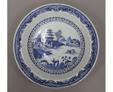 An 18th century Chinese blue and white porcelain circular dish painted with a pagoda and figures in a landscape. 23.5 cm diam