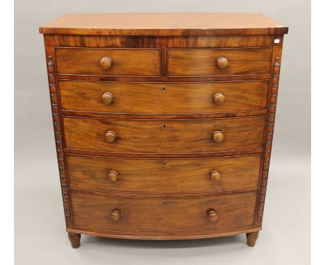 A Georgian mahogany bow-front two-over-four chest of drawers. 117 cm wide x 130 cm high.