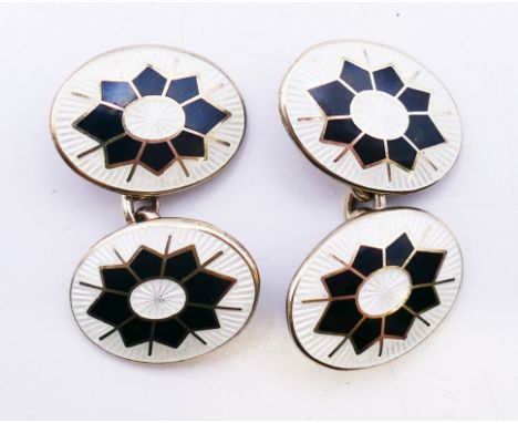 A pair of silver and enamel cufflinks, in a Duchamp box.  2 cm high. 