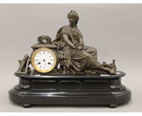 A large Victorian slate mantle clock surmounted with a female figure. 55 cm wide.