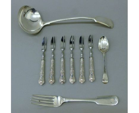Six silver-handled cake forks, a silver fork, a silver teaspoon and a silver-plated ladle. The latter 28 cm long. 94.2 gramme
