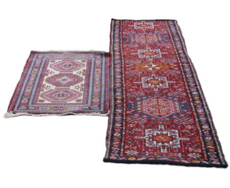 Two vintage red ground rugs. The largest 230 cm long.  