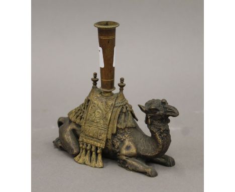A brass-mounted silver-plated camel-form candlestick. 15 cm long.
