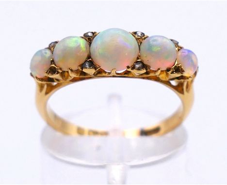 An 18 ct gold opal and diamond ring. Ring size M/N. 3.5 grammes total weight.   
