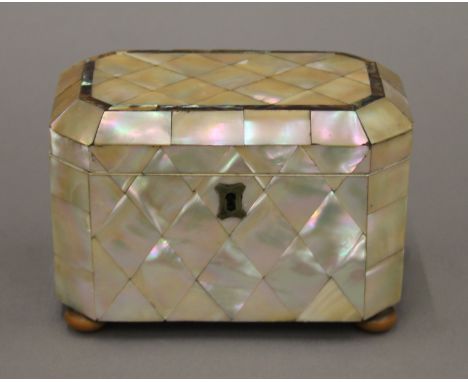 A Victorian mother-of-pearl tea caddy and a silver caddy spoon. The former 15.5 cm wide.