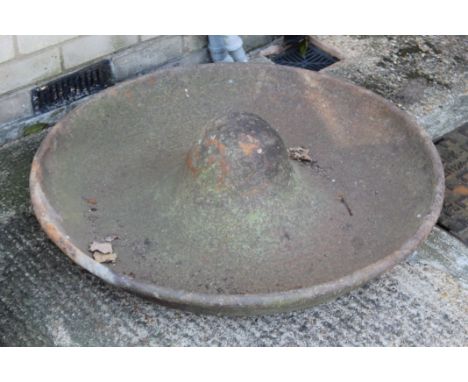 A Mexican hat cast iron pig feeder. 82 cm diameter. 