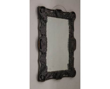 A 19th century carved oak mirror. 50 x 69 cm.