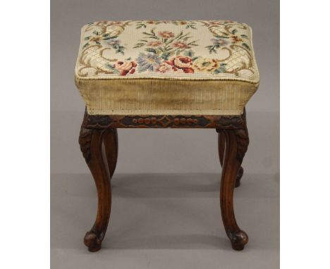 A Victorian carved walnut tapestry-topped stool. 40 cm wide x 47 cm high.