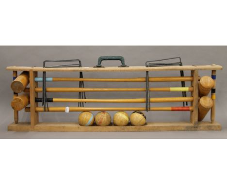 A croquet set on stand. 95 cm long.