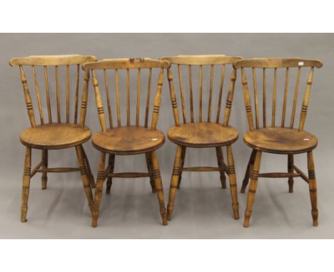 A set of four Victorian penny-seat stick back kitchen chairs. 48 cm wide.