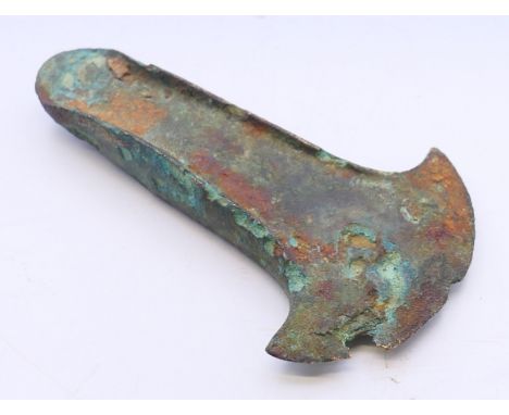 A Bronze Age bronze axe head, dug up between Ely and Queen Adelaide.  9 cm high. 