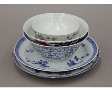 Two 18th century Chinese porcelain blue and white plates, a blue and white flared bowl and two polychrome shallow bowls. The 