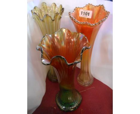 A Carnival glass tall vase with green and marigold shaded finish - sold with two similar examples, one light green, the other