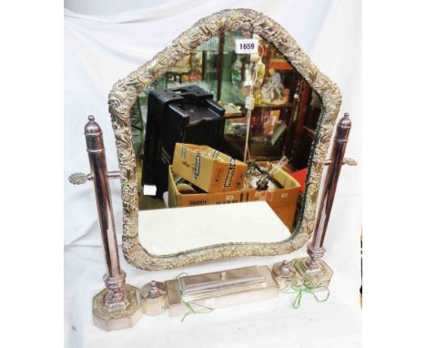 A vintage ornate silver plated framed platform dressing table mirror with cast floral scroll border to shaped plate, central 