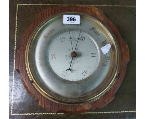 An old oak cased aneroid wall barometer by Shortland Bros.