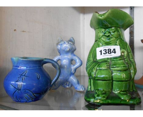 A C.H. Brannam Barnstaple art pottery green glazed toby jug - sold with a figurine depicting a standing cat and a small blue 