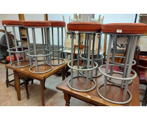A set of eight vintage bar stools with upholstered tops, set on grey painted metal bases - sold with another