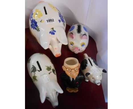 A small quantity of ceramic items comprising Babbacombe pottery piggy bank, three other similar and a Babbacombe pottery figu