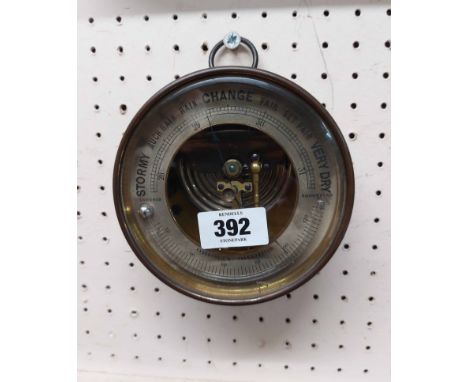 An antique brass cased sedan style aneroid barometer by Dubois &amp; Casse with silvered outer dial, visible works to dial ce