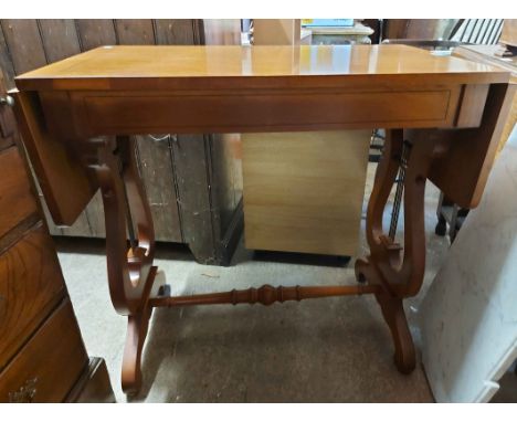 An 80cm reproduction sofa table with single frieze drawer, set on pierced lyre-shaped standard ends