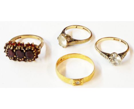 A 9ct. gold garnet cluster ring, two 9ct. white paste solitaire rings and a yellow metal band (marks worn) - sizes M 1/2, P, 