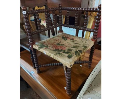 A late Victorian stained wood bobbin turned corner chair with upholstered seat