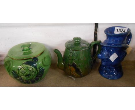 A C.H. Brannam Barnstaple art pottery teapot with sgraffito and coloured slip decoration depicting butterflies and incised mo