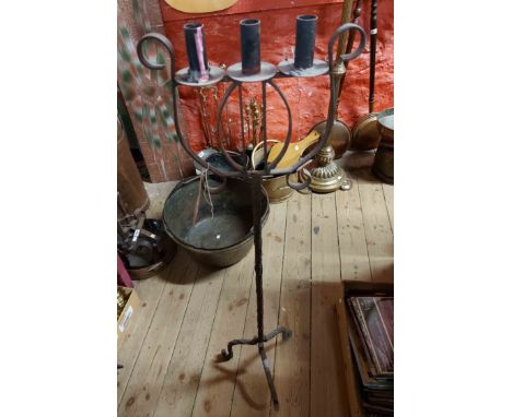 A vintage wrought iron floor candelabrum with decorative harp motif and three candle sconces