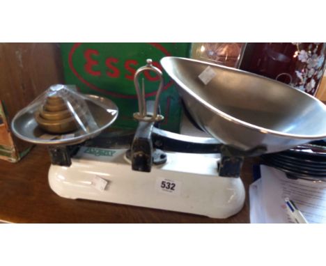 A set of vintage Avery scales with enamel base, metal pans and set of graduated brass weights