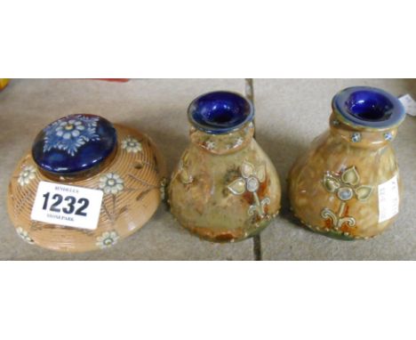 A Doulton Lambeth salt glaze stoneware lidded inkwell with decorative applied flowers and dip pen holes - sold with a pair of
