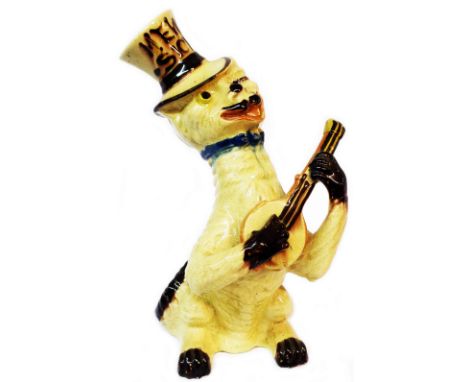 A rare 19th Century Watcombe Pottery 'Mew-Sick' cat figurine, depicting a winking cat wearing a top hat and playing a guitar,