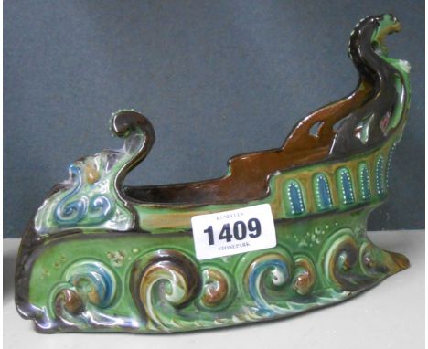 A C.H. Brannam Barnstaple art pottery posy vase in the form of an Art Nouveau galleon with coloured slip decoration on a gree