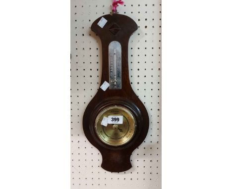 A vintage stained wood framed banjo barometer by Shortland Bros., with aneroid works and thermometer scale