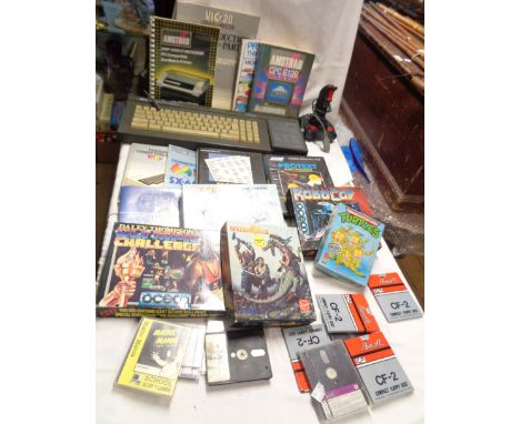 A box containing an Amstrad 128K colour personal computer Model CPC6128 with manual - sold with a quantity of games and progr