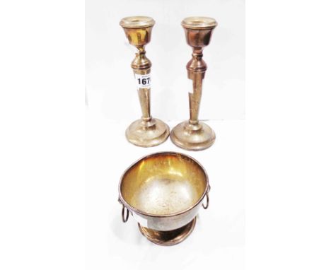 A pair of 18cm high silver candlesticks with loaded circular bases - sold with a small silver footed bowl with flanking lion 