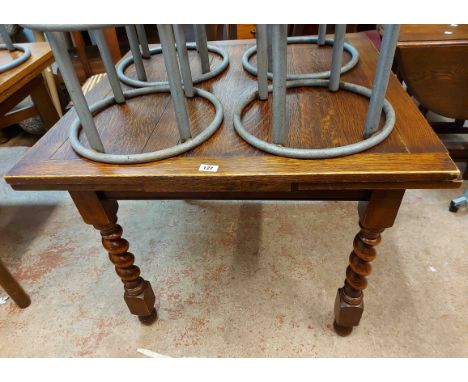 A 91cm vintage oak draw-leaf dining table, set on heavy barley twist legs