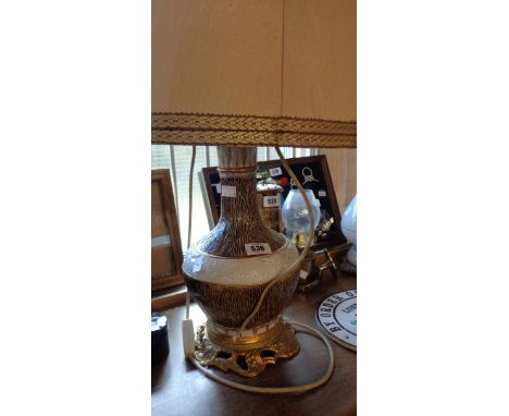 A large Italian porcelain lamp base with moulded floral and textured decoration and gilt metal fittings - sold with large sha