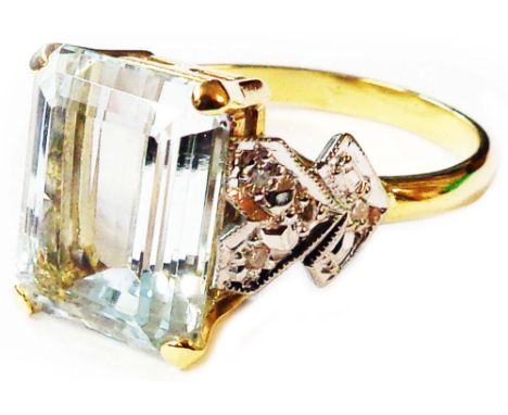 A 750 (18ct.) gold ring, set with large central emerald cut aquamarine and flanking small diamonds to shaped shoulders - size