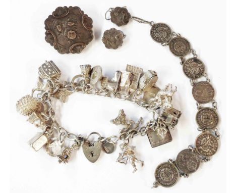 A white metal charm bracelet, set with numerous 925, silver and white metal charms - sold with a silver brooch with glass pan