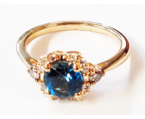 An import marked 585 (14ct.) rose gold ring by Le Vian, set with central circular blue topaz within a tiny diamond border wit