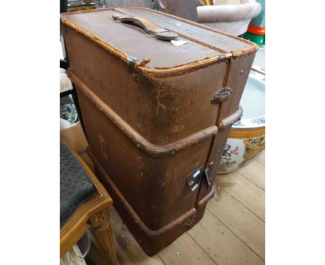 A 70cm old cane bound canvas travelling trunk with internal lift-out tray and flanking leather strap handles - bearing brass 
