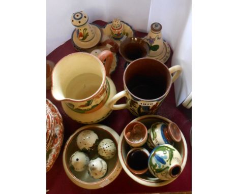 A quantity of Torquay pottery motto ware in the Scandy and other patterns including jug, inkwell, bowls, egg cups, loving cup
