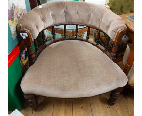 An Edwardian stained wood framed tub elbow chair with button back upholstery, set on turned front legs