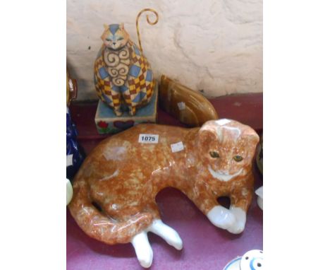 A large Winstanley reclining ginger cat figurine - sold with a small stylised pottery cat figurine and a large Heartwood Cree