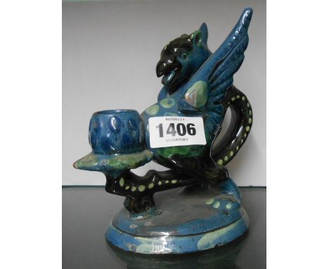 A C.H. Brannam Barnstaple pottery chamberstick in the form of a gryphon with coloured slip decoration and blue and brown glaz