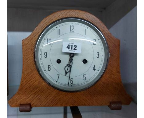 A vintage oak cased mantel clock with Enfield eight day gong striking movement