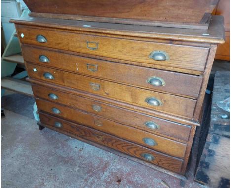 A 1.2m vintage oak two part plan chest with flight of six shallow drawers with brass cup handles and file name card slides, s