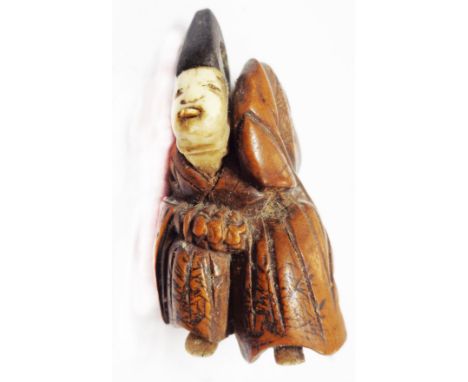 A 19th Century Japanese carved hardwood netsuke with carved bone face and feet