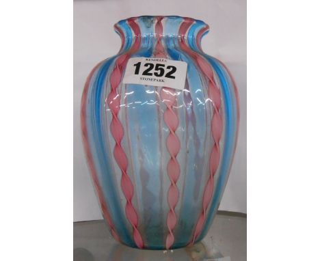 A vintage Venetian glass vase with internal pink candy twist decoration on a light blue ground