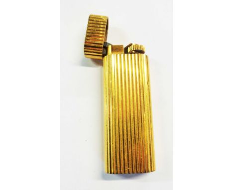 A Cartier (Paris) gold plated cased cigarette lighter with ribbed finish - No.39624D - minor wear